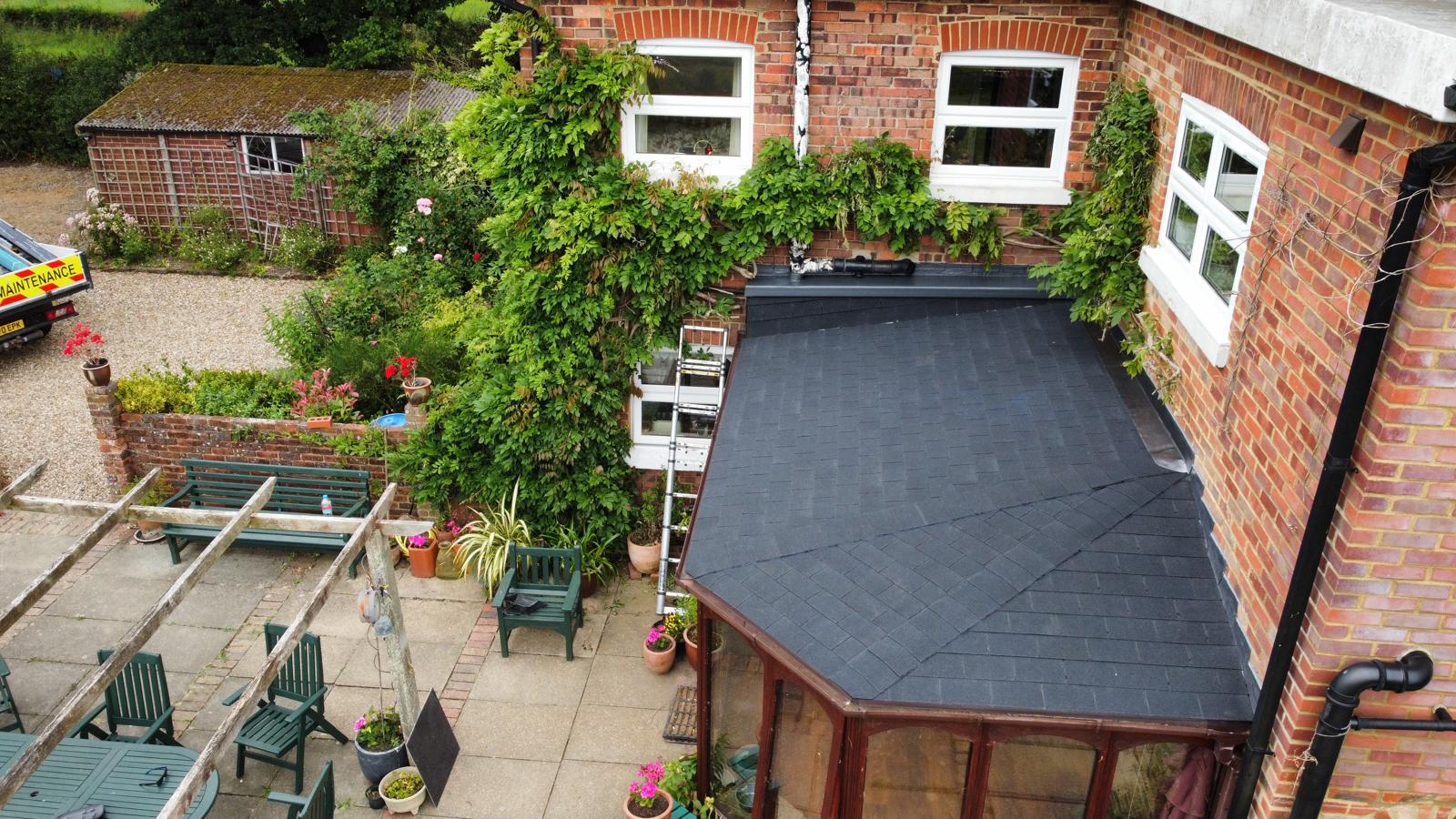 old conservatory roof that’s been turned into a felt shingle roof