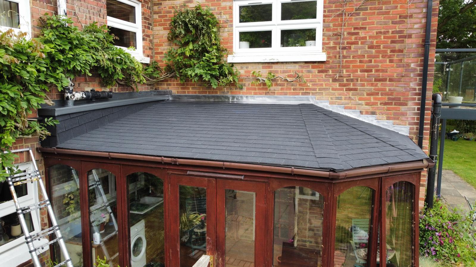 old conservatory roof that’s been turned into a felt shingle roof