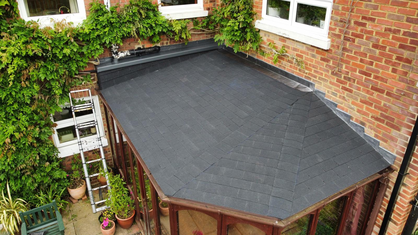 old conservatory roof that’s been turned into a felt shingle roof